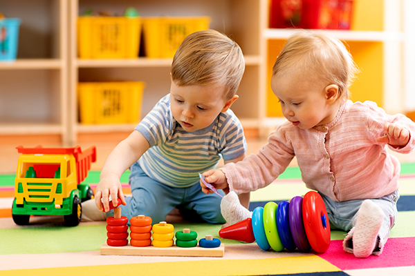 Preschool,Boy,And,Girl,Playing,On,Floor,With,Educational,Toys.