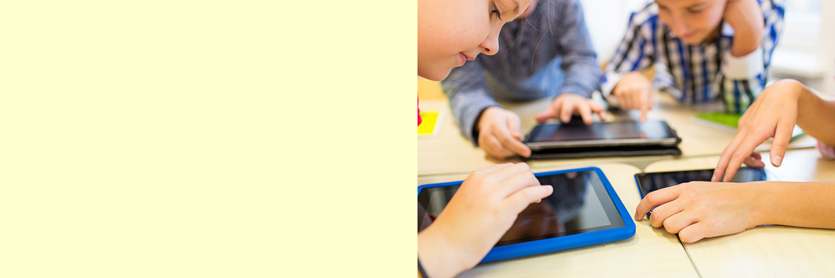 Mehrere Kinder arbeiten mit Tablets in der Schule