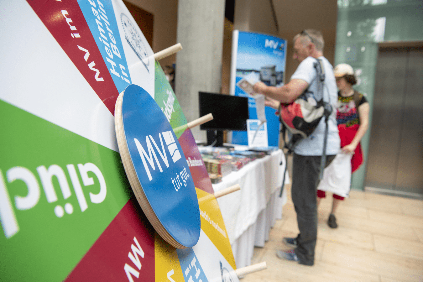 Die Scheibe eines Glücksrades mit dem MV-Logo darauf.